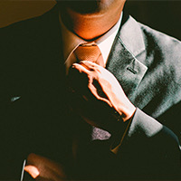 Man adjusting tie